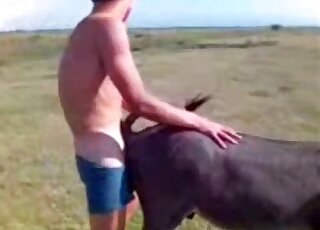 Dude pulls down his undies to fuck a sexy black dog outdoors here